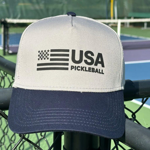 Cap with 'USA Pickleball' logo on a tennis court background